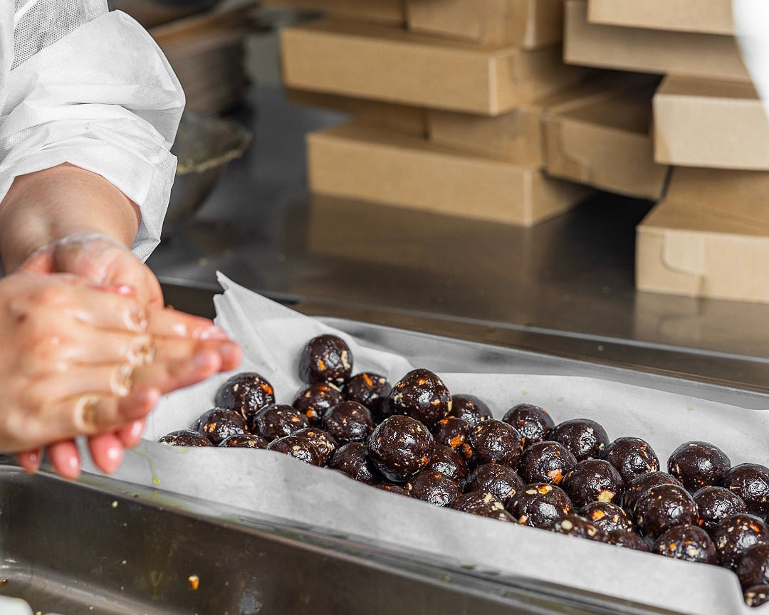 Raspberry Tesstimony slice next to cup of tea on white marble plate.